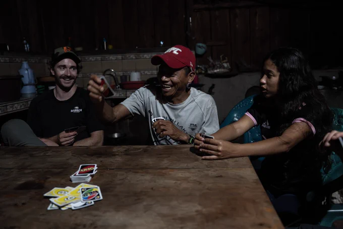 A group of Trekkers and locals playing the card game Uno late at night.