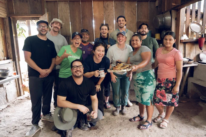 Group photo celebrating a meal they made together.