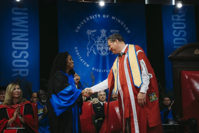 Dr. J.J. (John-Justin) McMurtry shakes Board of Governor hand.