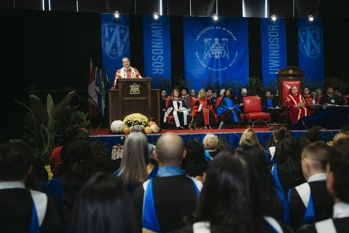 Dr. J.J. (John-Justin) McMurtry speaks at Convocation in front of graduates.