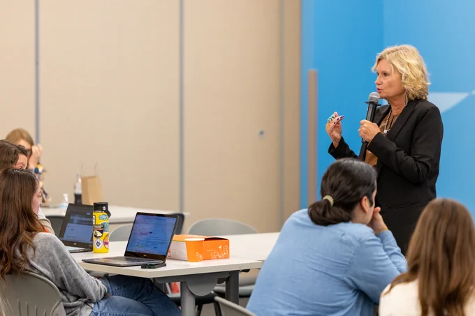 Renee Smith-Faulkner, superintendent of Castleberry ISD, is presenting to a group of attentive educators with laptops visible on the tables.