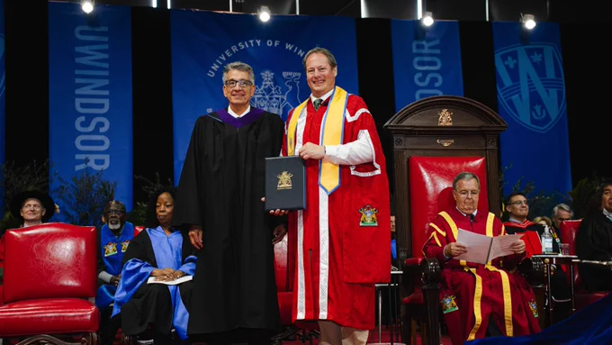 University of Windsor President J.J. McMurtry, right, presents Prof. David Tanovich with the title of Distinguished University Professor during the Fall 2025 Convocation ceremony