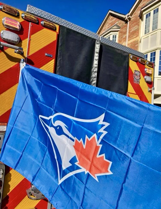 Toronto Blue Jays flag hanging off the back of a Toronto Fire Services fire truck.