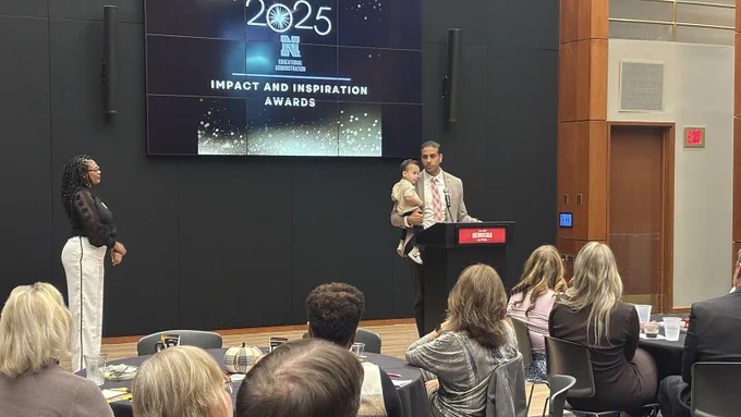 Harnoor Dhaliwal holds his son, Lincoln, while speaking at the EDAD Impact and Inspiration Awards