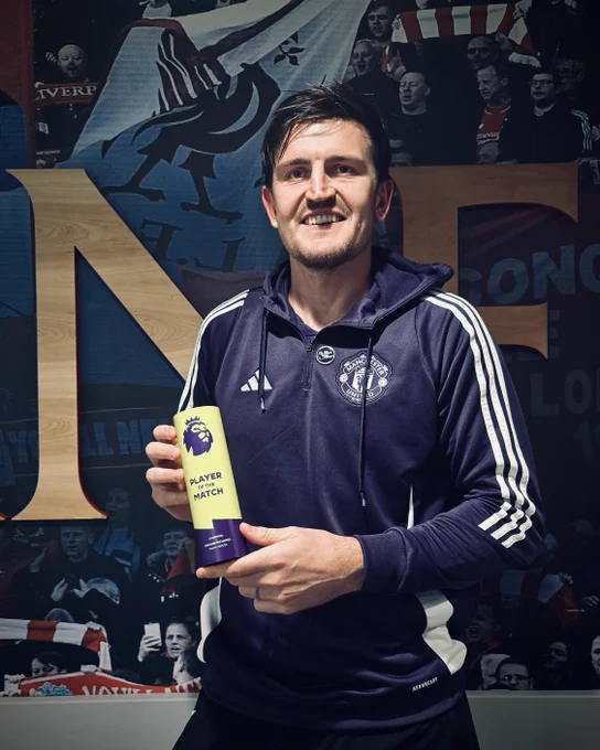 Harry Maguire poses with the Player of the Match trophy.