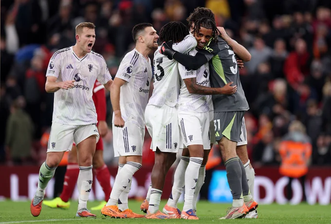 United's defenders celebrate with Senne Lammens.
