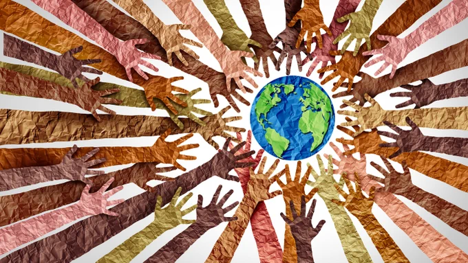 Arms made of different coloured paper, with scrunched texture, all reaching towards a globe of the world, also made of blue and green paper.
