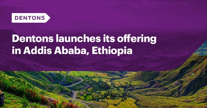 Vibrant terraced fields in Ethiopia with green and yellow patches, overlaid with a purple banner. White text reads 'Dentons launches its offering in Addis Ababa, Ethiopia.' Dentons logo appears in the top left corner.