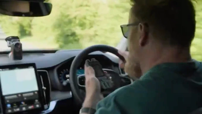 a hunter driving with a poc (push-to-talk) handset on a public road in the uk