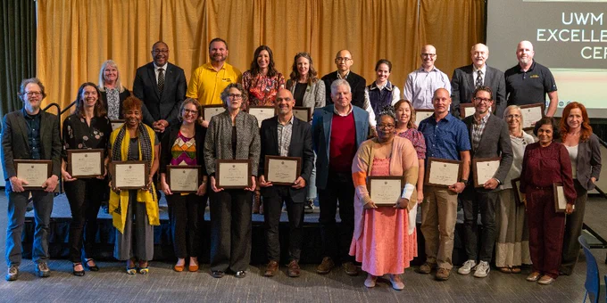 The recipients of UWM's Employee Excellence Awards pose for a group photo with Chancellor Gibson.