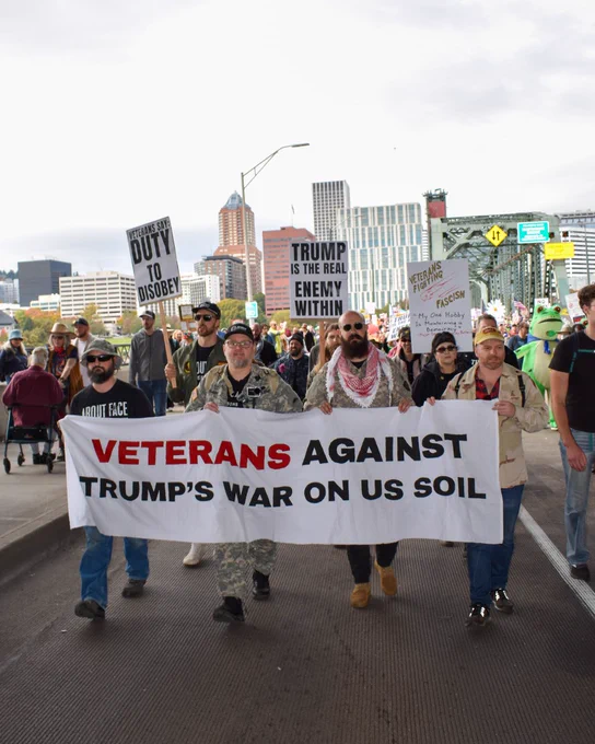 People peacefully marching during the second No Kings protest on Saturday, Oct. 18, 2025. Sign reads: Veterans Against Trump’s War on U.S. soil