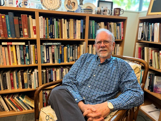 Stephen Skowronek seated in his office in front of bookshelves