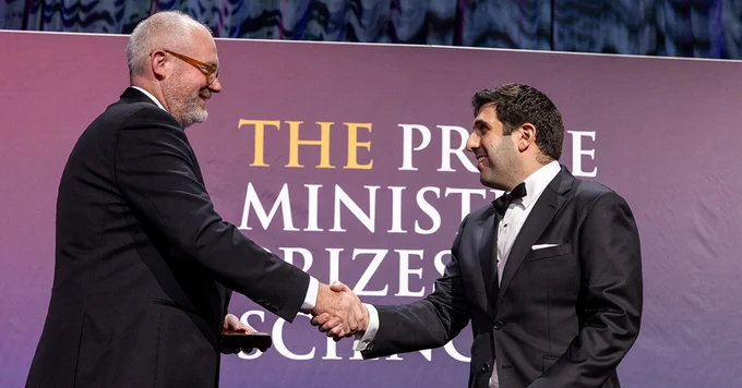 David Khoury receiving his prize from Senator the Hon Tim Ayres, Minister for Industry and Innovation and Minister for Science
