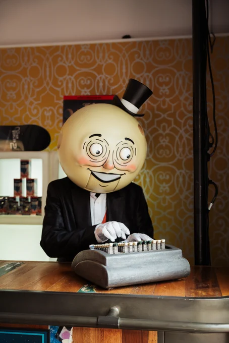 An image of Moon Man from The Outer Worlds 2 typing on a typewriter