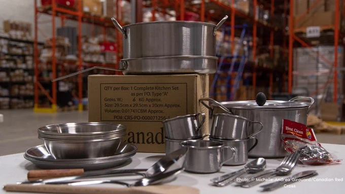 A kitchen set, including pots, pans, cutlery, and cooking utensils. 
