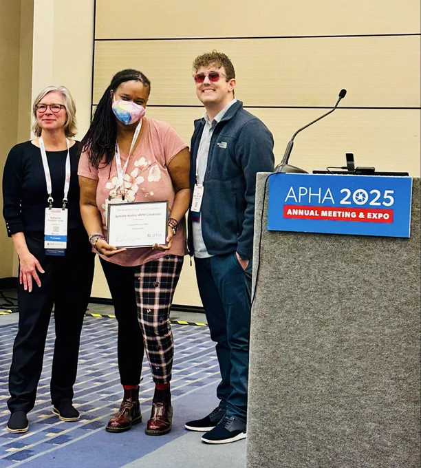 Syreeta, Katherine and Tyler stand together and smile at awards ceremony