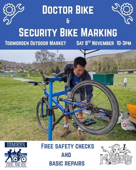 A promotional flyer for a cycling event at Todmorden Outdoor Market. The top section has a blue background with white text that reads: “Doctor Bike & Security Bike Marking.” Below, it states the location and time: “Todmorden Outdoor Market, Sat 8th November, 10–3 PM.” The central image shows a bicycle mounted on a blue repair stand outdoors on a grassy field, with hills and trees in the background. Tools and equipment are visible near the bike. At the bottom, logos for “Todmorden Stroll and Roll” and “The Manky” are displayed alongside text: “Free safety checks and basic repairs.”