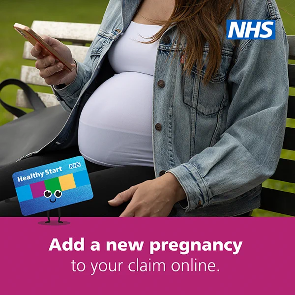 Person sitting on a bench holding a smartphone with a view of the NHS Healthy Start promotional image encouraging adding a new pregnancy to a claim online.