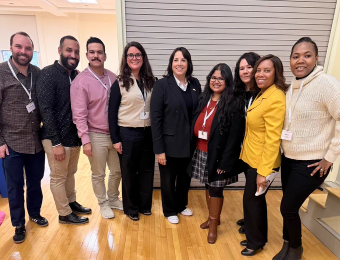 A group photo of the ASG team with Sabina Matos and Kim Driscoll. The team includes a wide range of races and ethnicities.