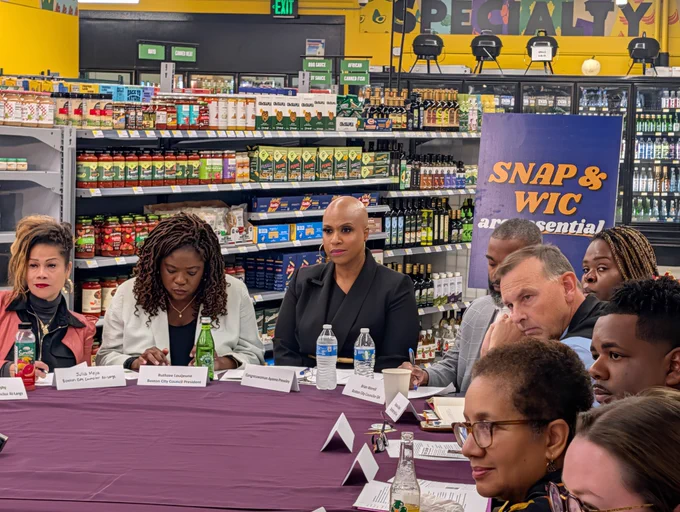 Rep. Ayanna Pressley and local elected officials listen to SNAP food retailers speak to threats to food assistance during the Republican government shutdown.
