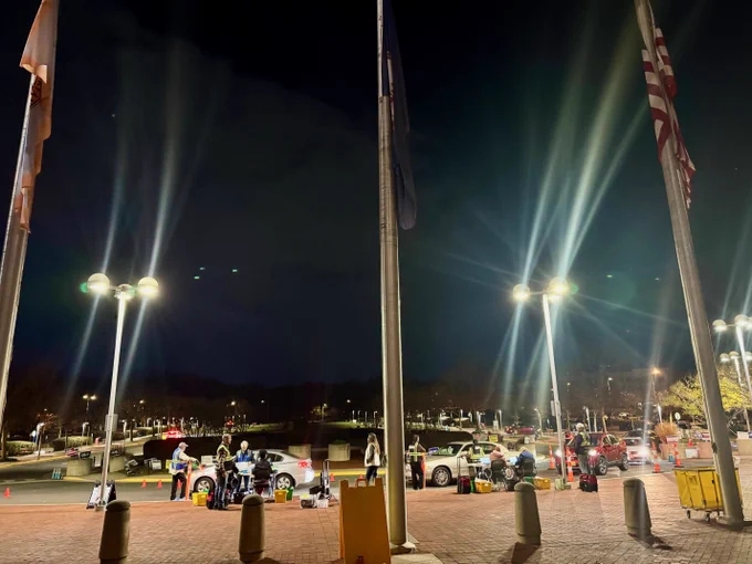 Night view of the Government Center with cars lined up delivering votes from precincts.