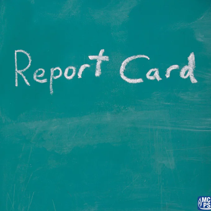 The words 'Report Card' written in white chalk on a green chalkboard with faint chalk marks around.
