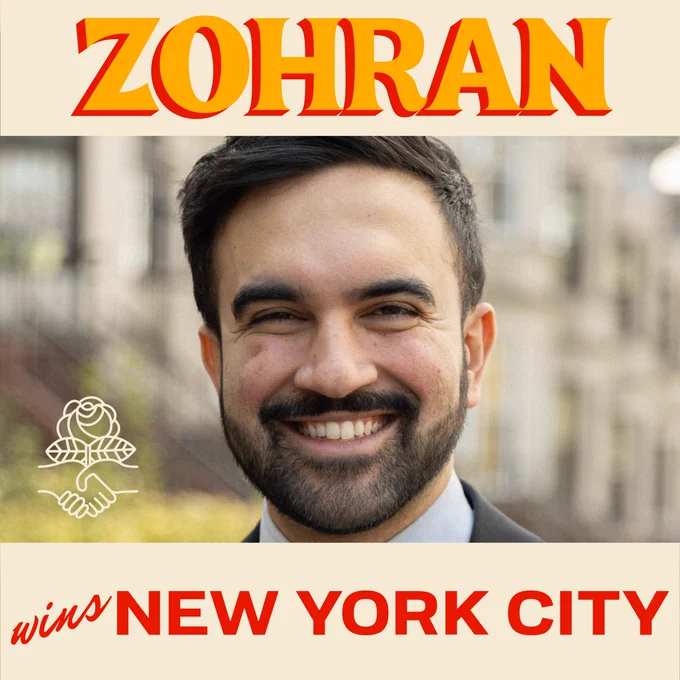 Zohran wins New York City. Photo of Zohran Mamdani smiling, with a soft-focus view of New York apartment buildings in the backgroud, DSA logo: a rose rising from two clasping hands.