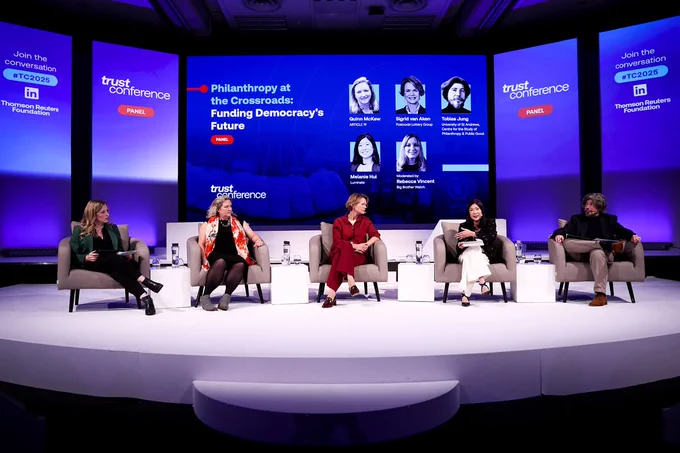 A photo of five panellists on the stage for the session titled: Philanthropy at the Crossroads: Funding Democracy's Future.