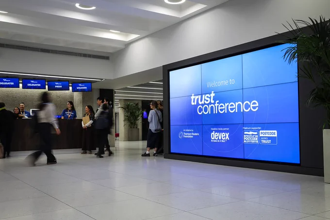 A photo of a Trust Conference branded screen at the entrance to the event.