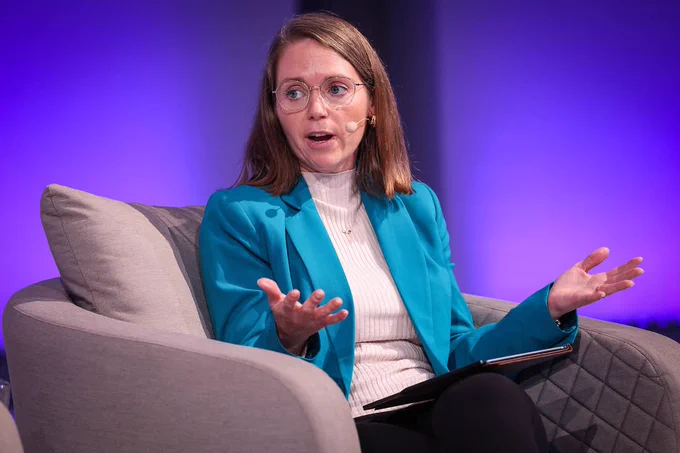 A photo of Laura Maher, Chief of Staff at Siegel Family Endowment talking on stage.