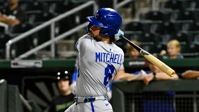 Blake Mitchell swings from the left side in a gray Kansas City Royals uniform at the Arizona Fall League