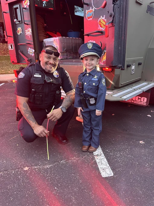 Police Officer with a kid dressed as a Police Officer
