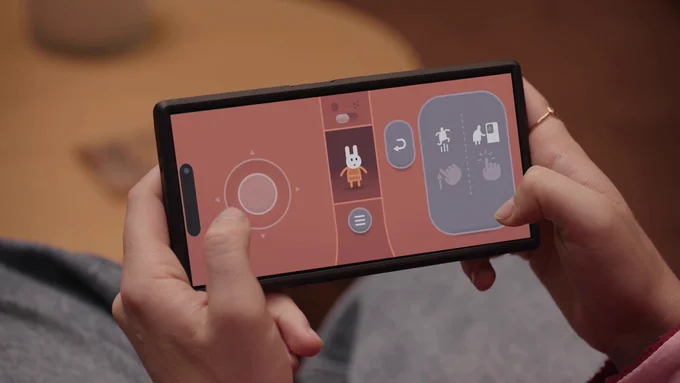 Closeup of phone being used as controller for Lovers in a Dangerous Spacetime. Controller shows touchable buttons and an icon of the player's bunny character