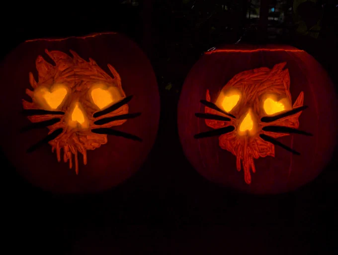 Pumpkins carved based on Dan and Phil's "take me back to 2009" sweater design, in various lighting.