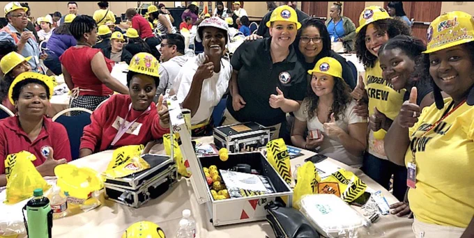 Team members celebrate success during Venture Up’s “Escape the Case” team-building challenge in Phoenix, Arizona.