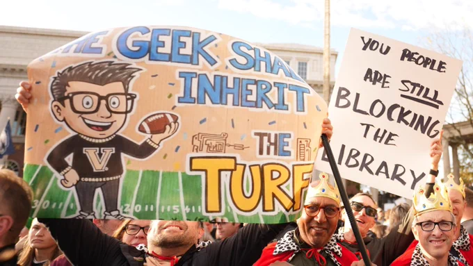Sigsn reads: "The Geek Shall Inherit the Turf" and "You people are STILL blocking the library" 