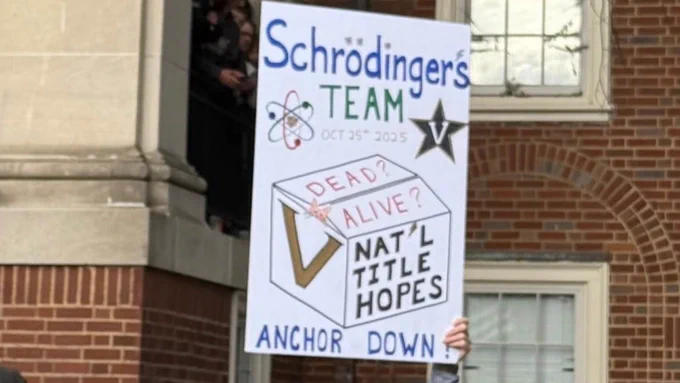 College GameDay sign reads: "Schrodingers Team: Dead? Alive? National Title Hopes." 