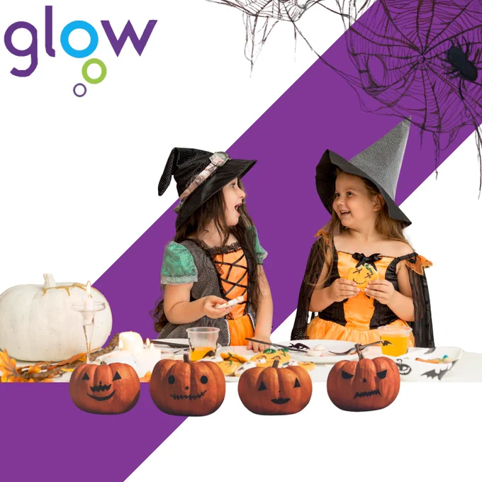 The image shows two children wearing Halloween costumes playing.