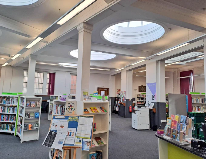 Interior photo of Library with white walls ceiling and circular skylights