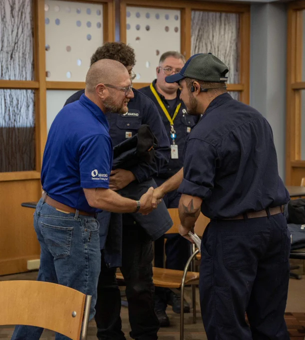 Graduates of Makino's 17-week PQS Training program being congratulated by Ben Indino, Makino's Customer Support Training Manager.