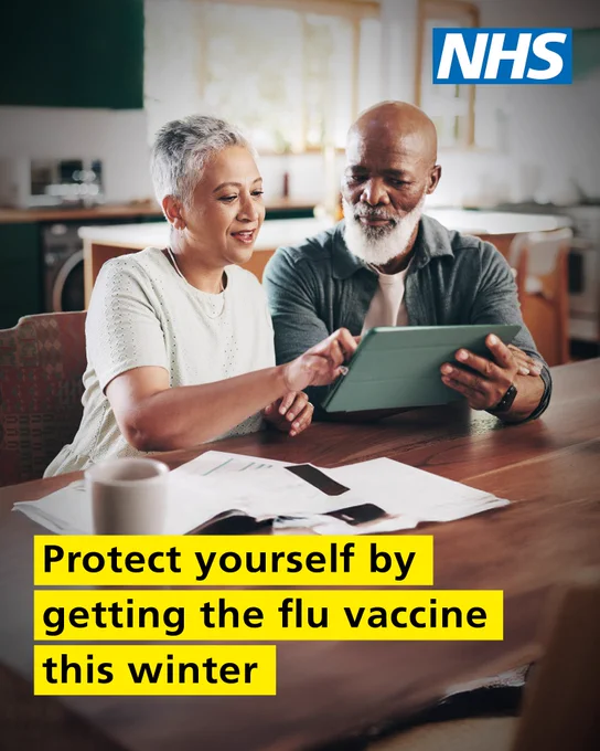 Two adults sitting at a table reviewing documents and using a tablet, promoting flu vaccination. Text reads 'Protect yourself by getting the flu vaccine this winter.'