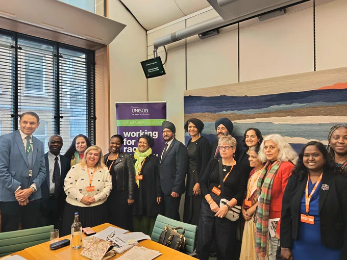 Photo of a activists and MPs in a parliamentary room at the Unison Black History Month anticaste event organized by AntiCaste Discrimination Alliance