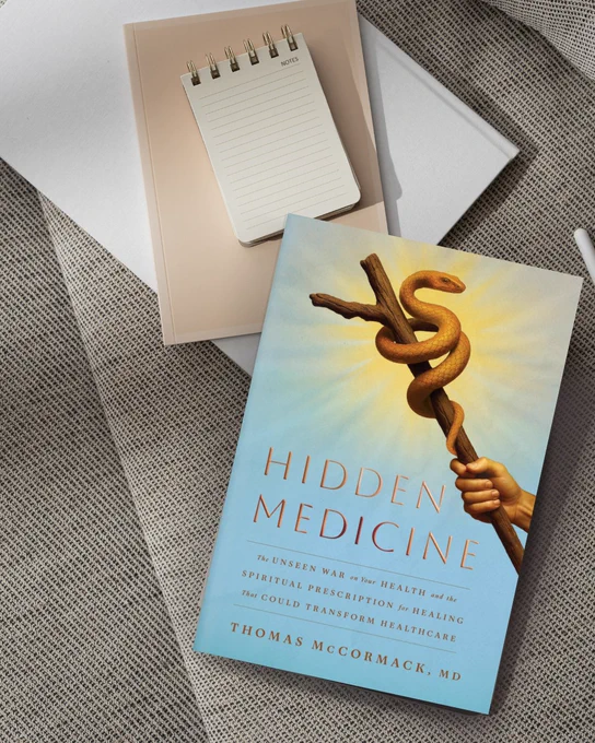 Hidden Medicine by Thomas McCormack, M.D with a stack of notebooks