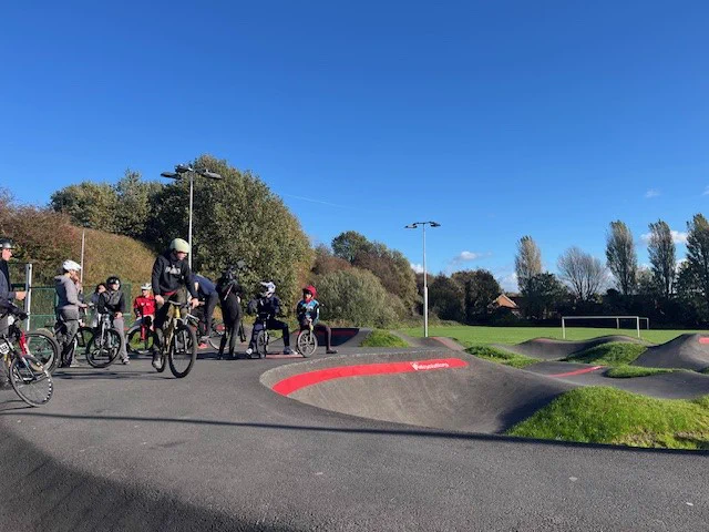 Photo of people on bikes on the pump track