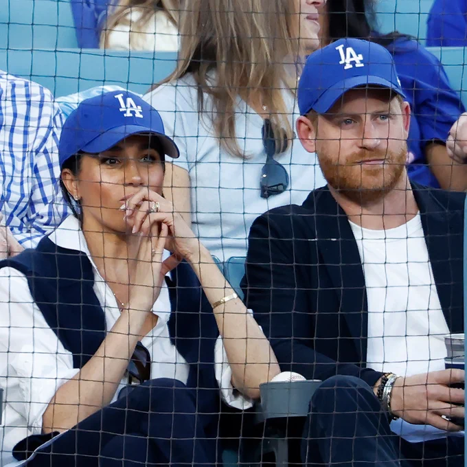 Prince Harry, Duke of Sussex and Meghan, Duchess of Sussex sitting in the stands at Dodger Stadium.