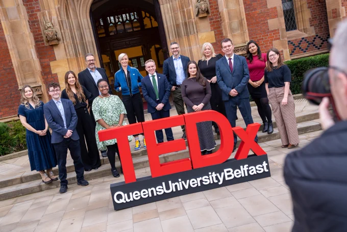 Image shows, from left to right, Dr Kathy Ruddy; Kieran David Robinson; Eimear O’Rourke; Professor Dominic Bryan; Dr Linda Oyama; Orla Smyth; Dr Ryan Feeney, Vice-President and Registrar at Queen’s; Richard Good, Director at The Turnaround Project; Aisling Cannon; Lorraine Marks; Professor Richard Miles, Provost and Deputy Vice-Chancellor at Queen’s; Niveda Vinyay; and Dr Emma Humphries, 

They are standing in front of the Lanyon Building with the TEDxQueensUniversityBelfast sign.