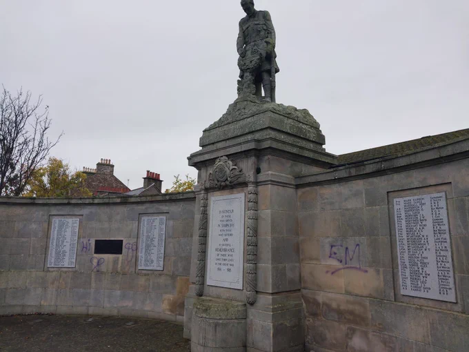 Image of Carnoustie War Memorial, defaced by purple spray paint in 4 places.