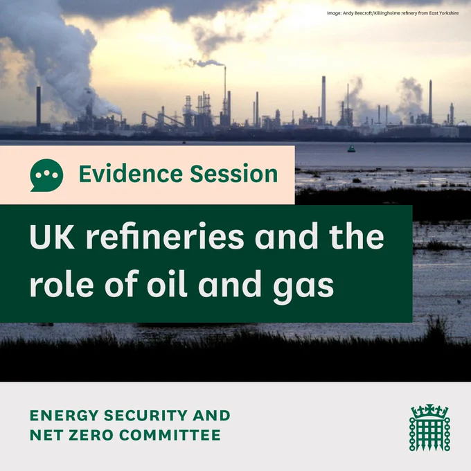Evidence session, UK refineries and the role of oil and gas. Energy Security and Net Zero. Photo is of a oil refinery, seen at a distance across water, with lots of chimneys with smoke billowing out of them.