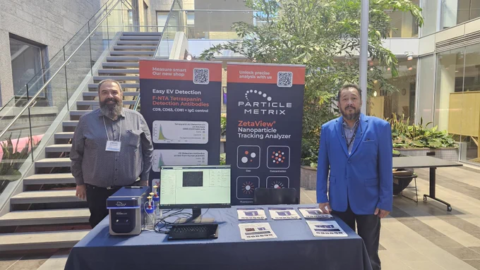 Particle Metrix GmbH booth at the ISEV Nervous Systems conference, showing Dr. Sven Kreutel and Rey Tesoro with the ZetaView® Evolution instrument.