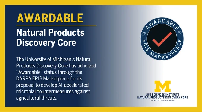 DARPA Awardable badge with text: The University of Michigan's Natural Products Discovery Core has achieved "Awardable" status through the DARPA ERIS Marketplace for its proposal to develop AI-accelerated microbial countermeasures against agricultural threats."